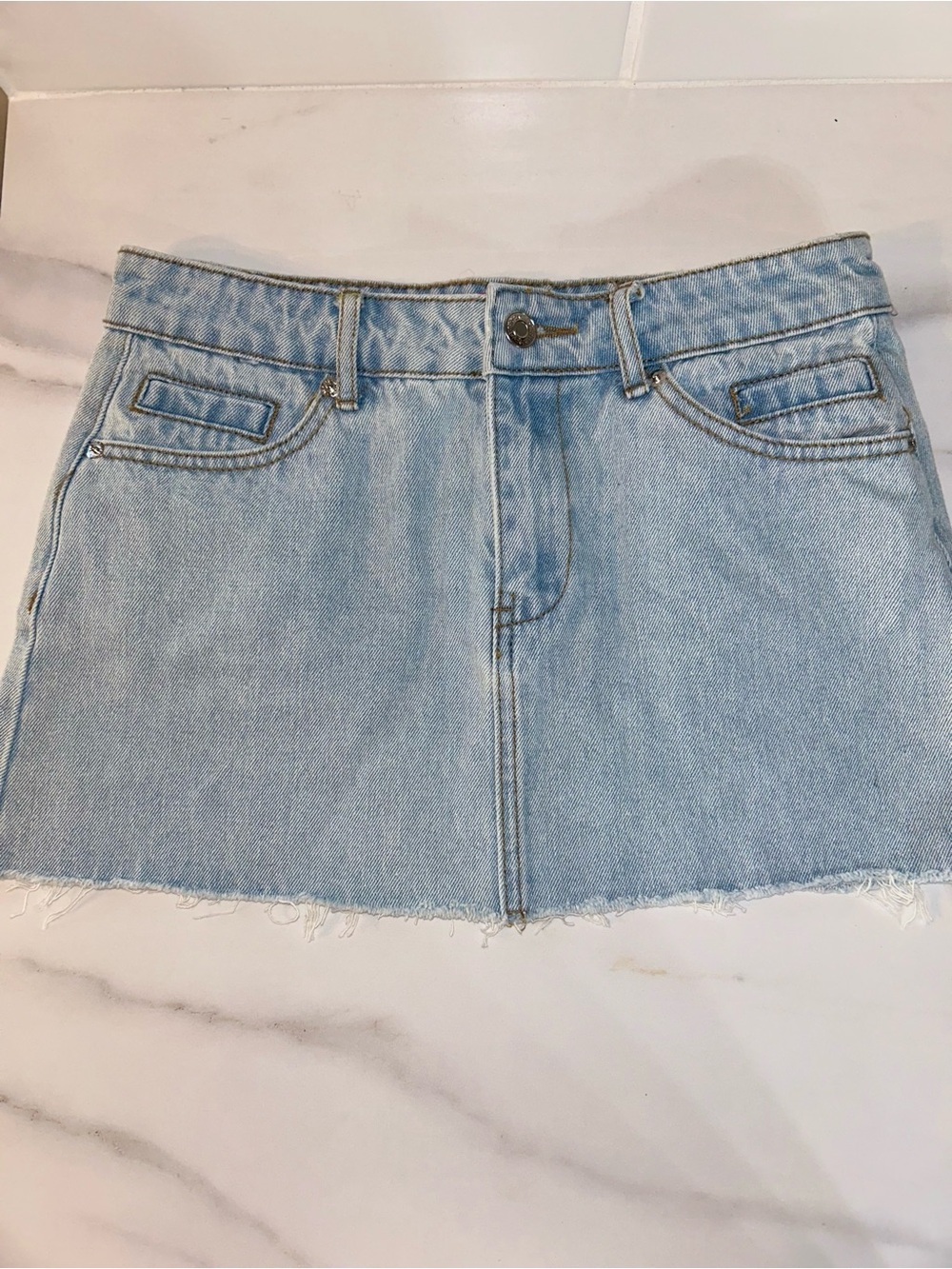 New with tags low rise light wash denim mini skirt from Edikted with frayed hem